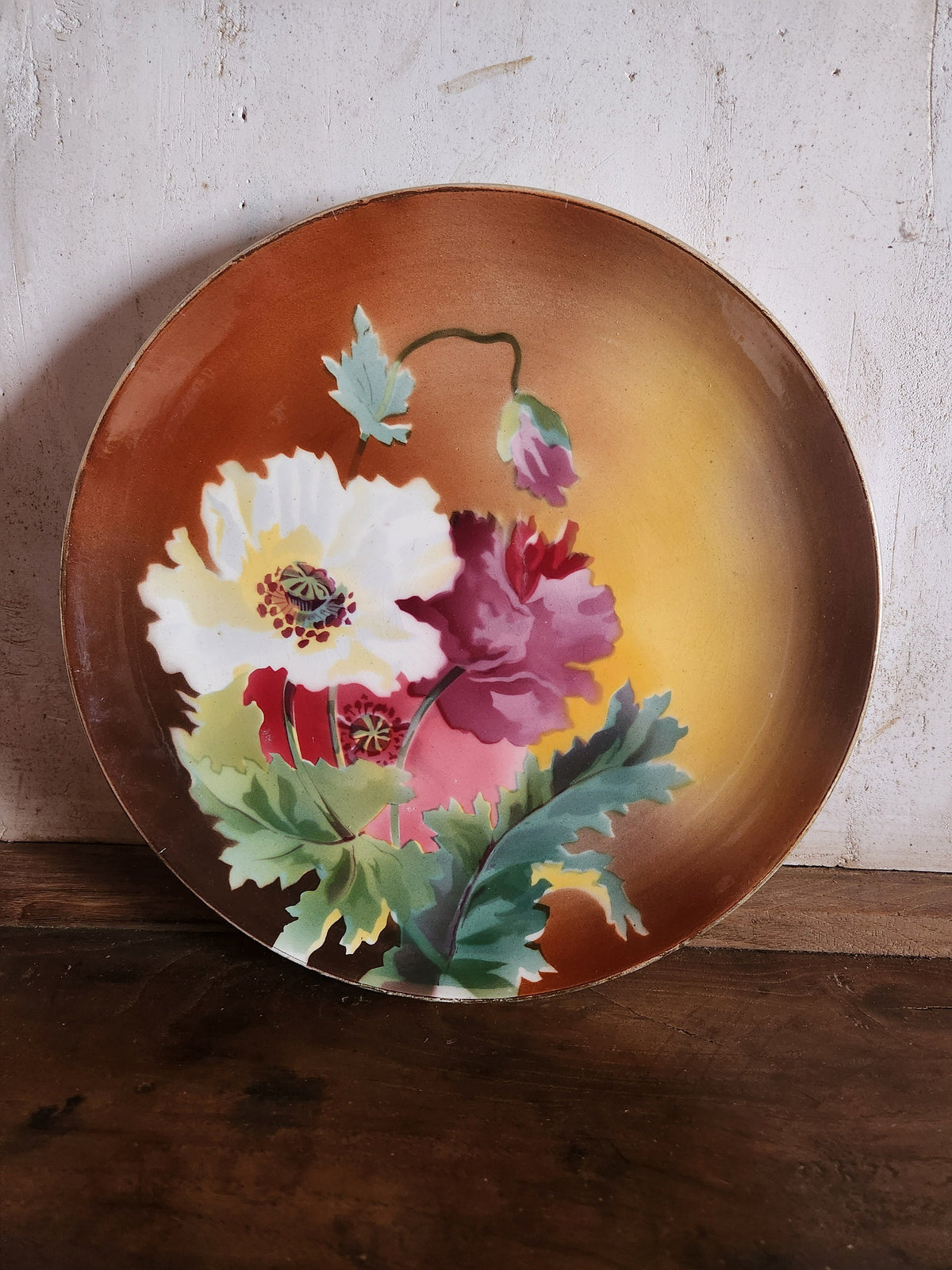 Close-up of hand-painted floral motif on antique French faience plate, Boulenger & Cie Choisy le Roi