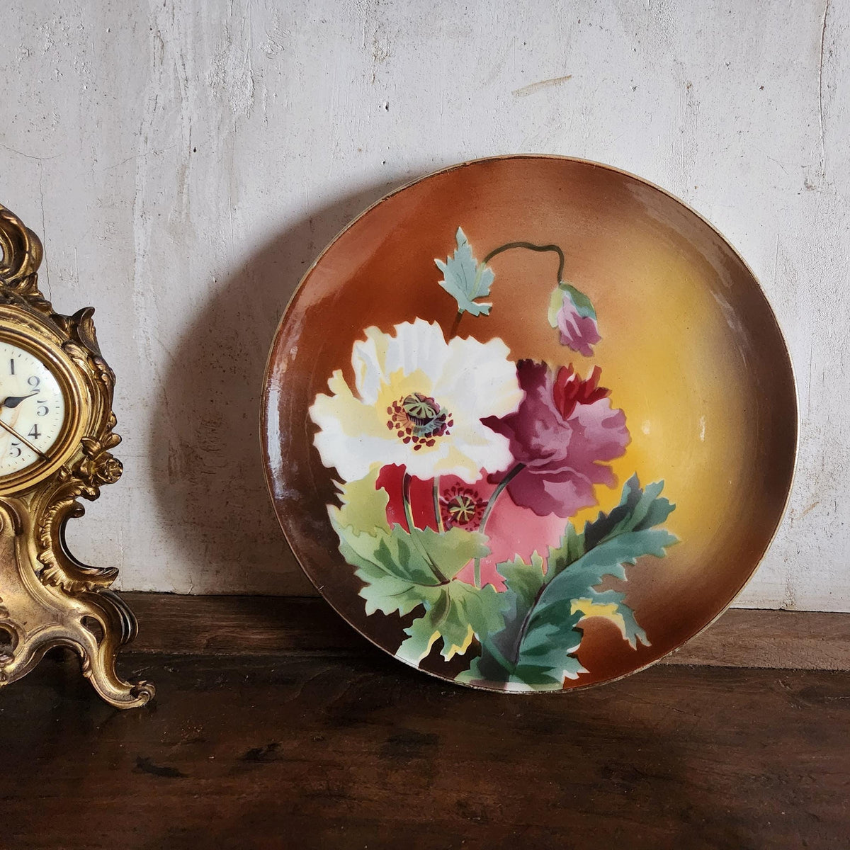 Close-up of hand-painted floral motif on antique French faience plate, Boulenger & Cie Choisy le Roi