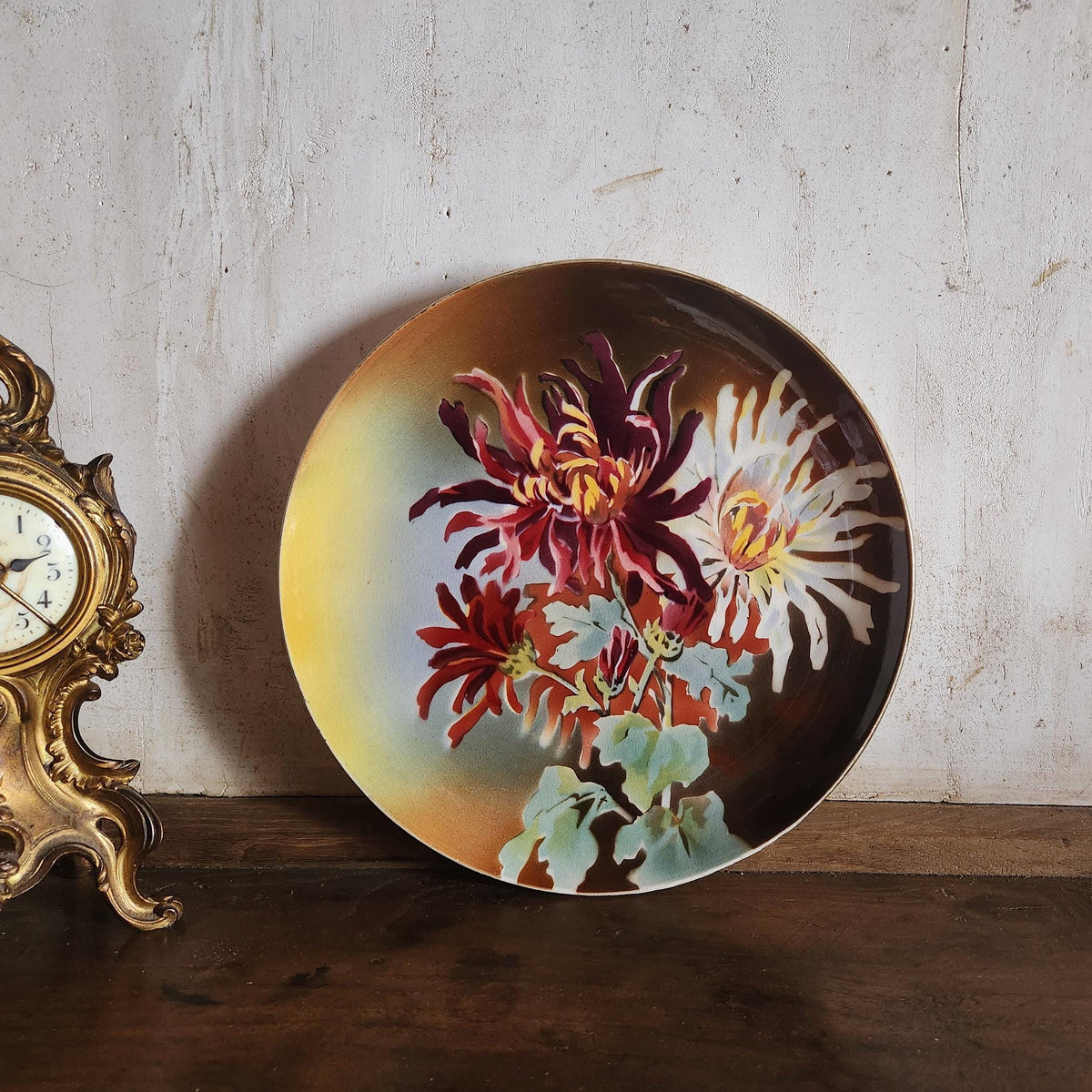 Close-up of hand-painted floral motif on antique French faience plate, Boulenger & Cie Choisy le Roi